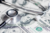 A stethoscope rests on a scattered pile of $100 bills
