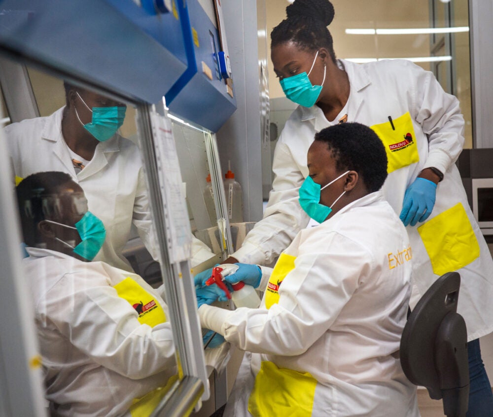 Medical scientists Melva Mlambo (standing) and Puseletso Lesofi prepare to sequence COVID-19 Omicron samples at Ndlovu Research Center in South Africa in December 2021.