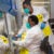 Medical scientists Melva Mlambo (standing) and Puseletso Lesofi prepare to sequence COVID-19 Omicron samples at Ndlovu Research Center in South Africa in December 2021.