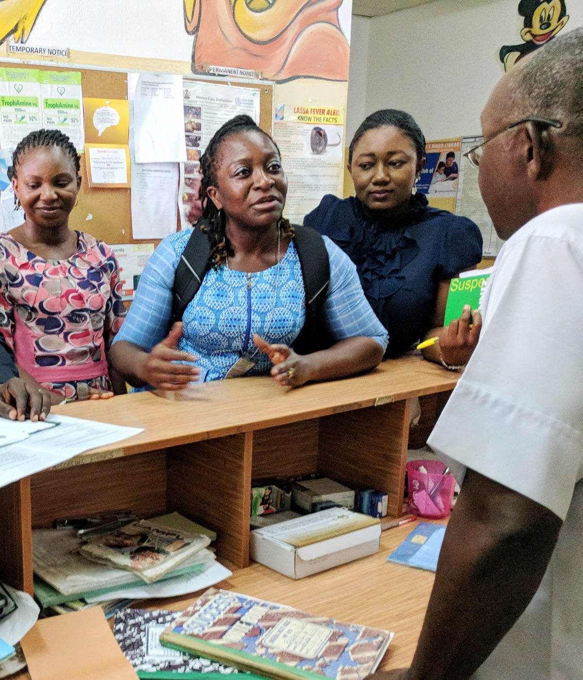 Nadia Sam-Agudu, center, and public health program officers checking on HIV testing at a pediatric unit
