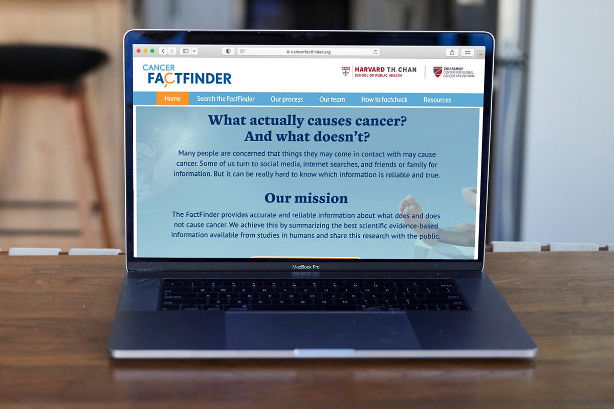 A laptop on a counter shows the homepage of "cancerfactfinder.org"
