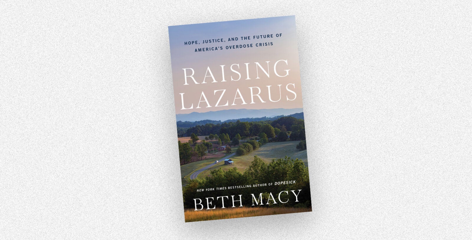 The book cover for "Raising Lazarus" by Beth Macy rests on a white-speckled background.