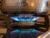 A textured pot sits upon a blue gas flame on a stove top.