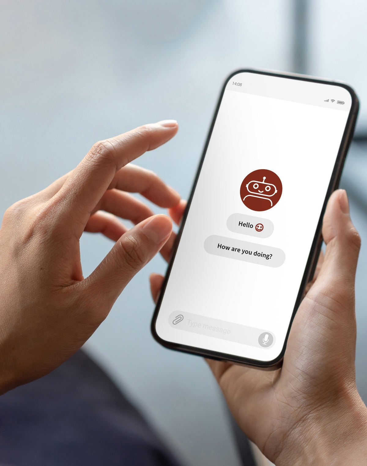 Two hands hold a smartphone displaying an image of an orange chatbot.