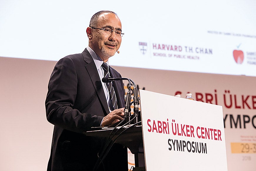 Gökhan Hotamışlıgil speaking at a Ulker Center Symposium branded podium. 