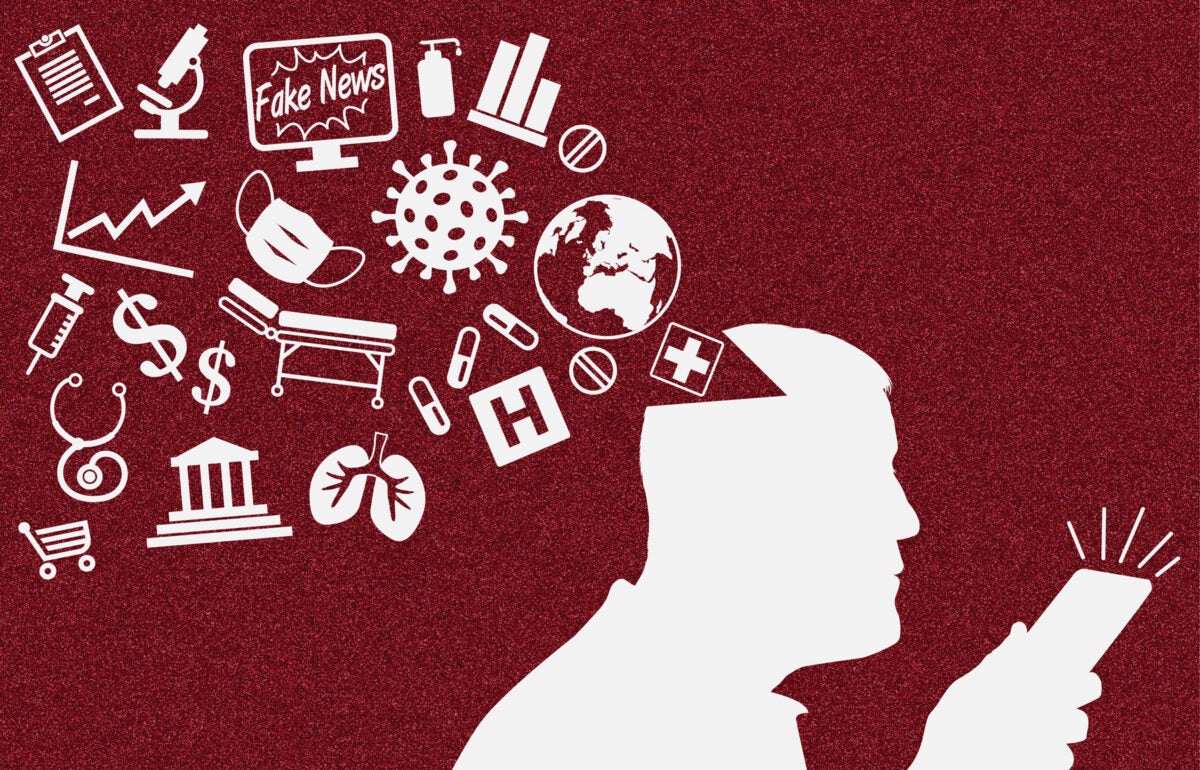 Illustration: Various healthcare icons and symbols “spill” from a man’s head while he looks at a cell phone. The figure is silhouetted in light grey against a grainy red background.