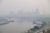 Photo of city buildings that are barely visible due to thick smoke.