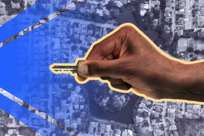 Photo illustration: A Black hand holds a key in a “unlock” position. The hand is on top of birdseye photo of a suburban houses, and there is a blue glow coming from the left side of the photo.