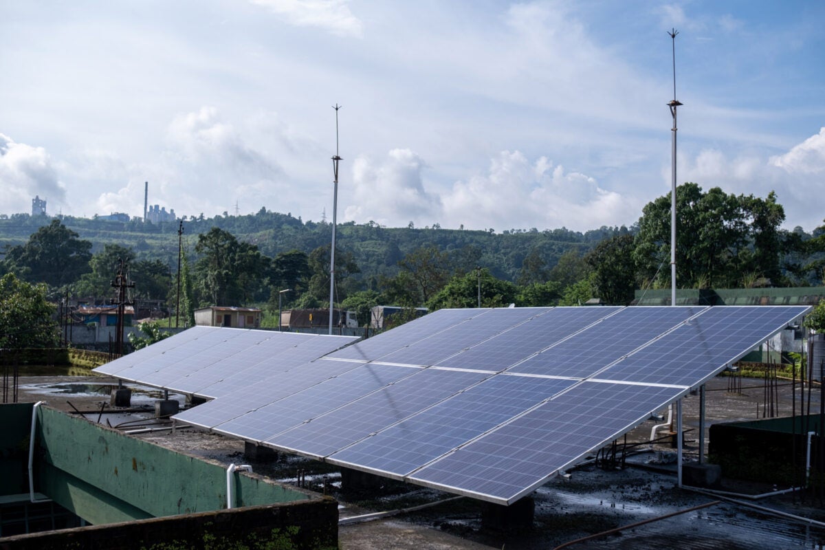 Installed solar panels on a concrete roof in Lumshong, India.