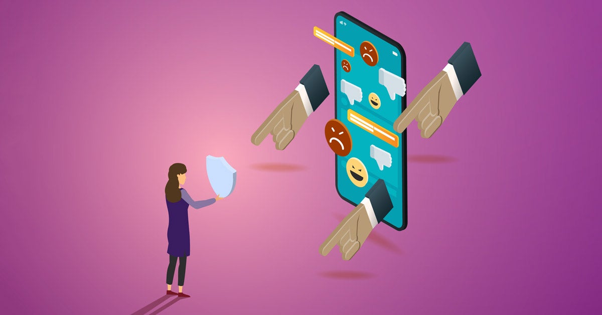Illustration: A female figure holds a shield in front of her body, blocking an oversized phone with pointing fingers, dislike icons, menacing emojis and text messages. The composition is on a purple-pink background.