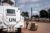 A white armored United Nations vehicle belonging to peacekeeping troops is parked outside of a base in Bangui, Africa.