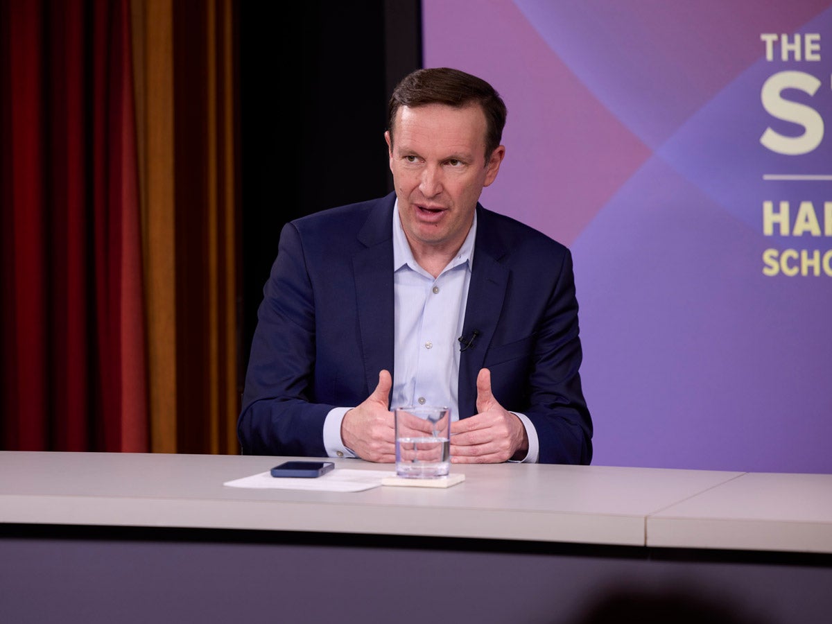 Senator Chris Murphy seated and speaking at a panel event.