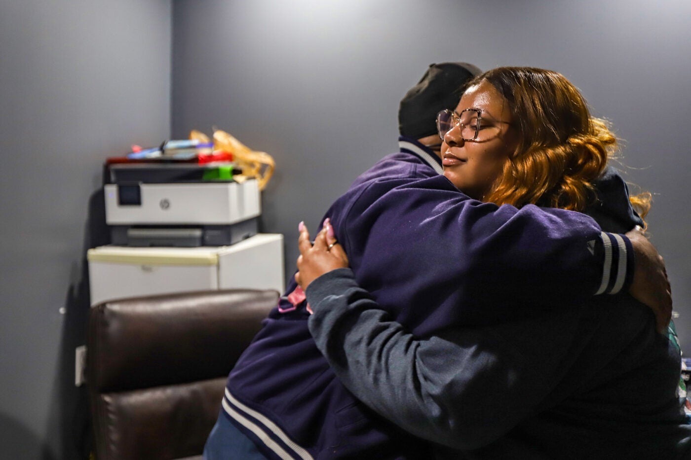 Dionna Brown and her father embrace inside his office.