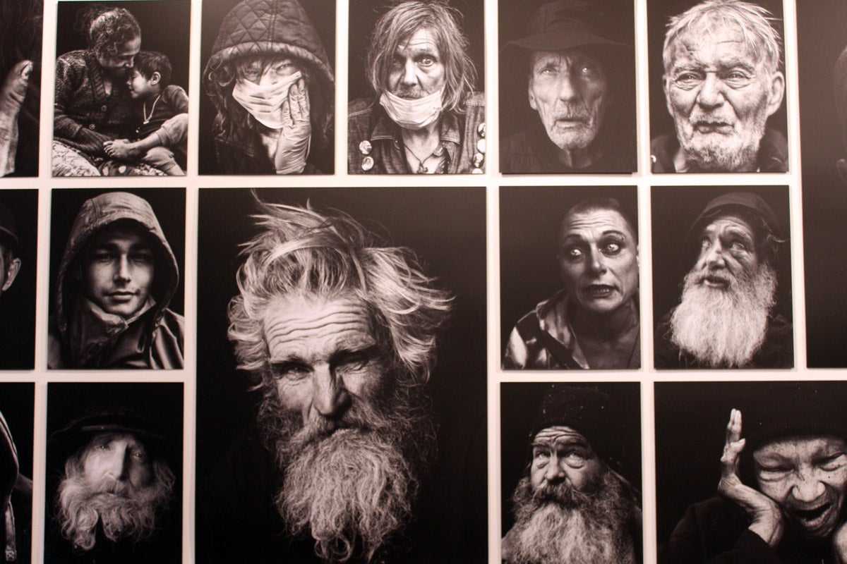 Close-up of black and white portrait photos of unhoused people in various expressions.