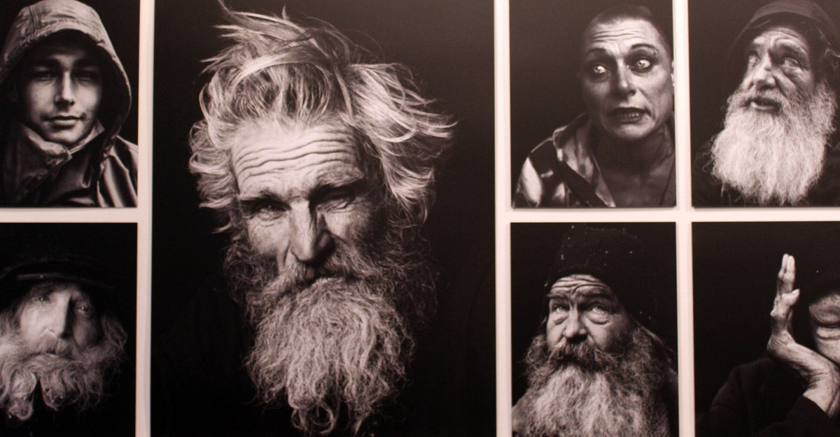 Close-up of black and white portrait photos of unhoused people in various expressions.