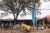 A street scene with a trailer filled with yellow water jugs and a bodega stall in Makina, Kibera, Kenya.