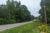 A two-lane highway on a wooded road outside Durham, North Carolina. The road has no sidewalks.