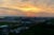 An aerial view of Reserve, Louisiana, at sunset. A large petroleum factory is visible.