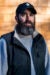 Rob Reider headshot, wearing a red jacket and a sad-dads baseball hat.