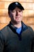 Christopher Piasecki headshot, wearing a red jacket and a sad-dads baseball hat.