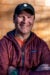 Jay Tansey headshot, wearing a red jacket and a sad-dads baseball hat.