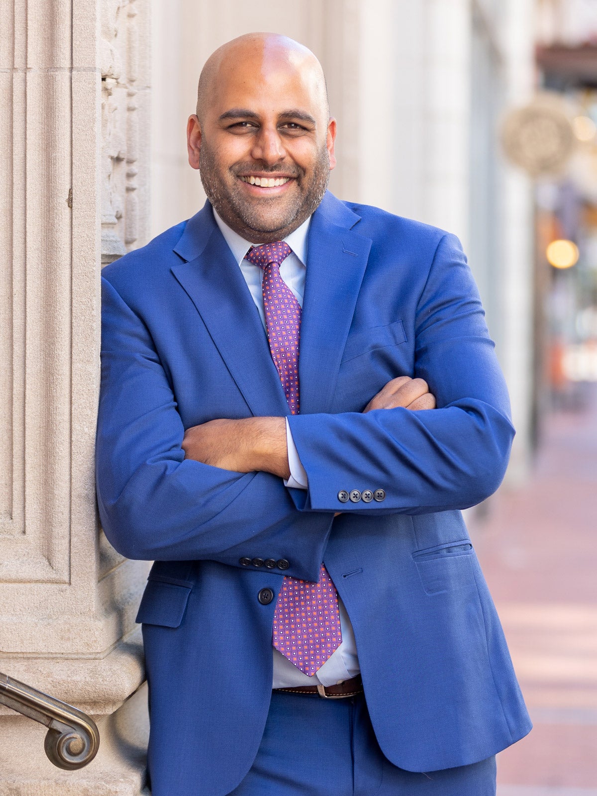 Hartford Mayor Arunan Arulampalam environmental portrait in downtown Hartford. He is wearing a true blue suit and purple patterned-tie.