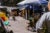 Children ride trikes on a plaza with booths and stalls in Mexico City.