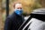 Matt Hancock wears a blue facemask that says "protect the nhs" while getting into a car.