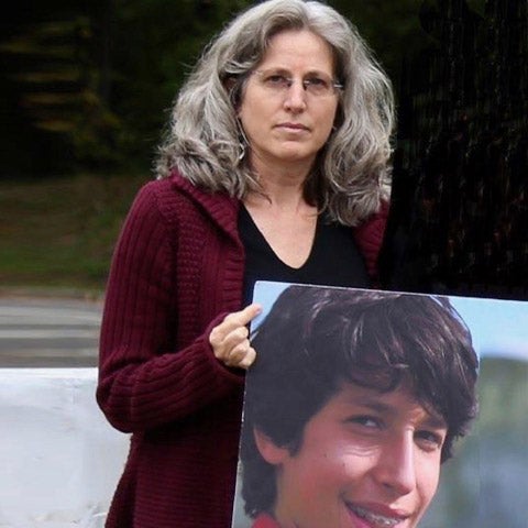 Amy Cohen holds a poster print of her son Sammy, who died in a traffic accident.